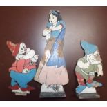 Walt Disney :- A cut-out wood figure of Snow White, together with two dwarves, one lacks stand,
