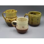 A Ray Finch Winchcombe Pottery jug, height 13cm, and two mugs, 1930s to 1960s.