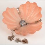 An Art Deco pink glass hanging ceiling shade, Reg. No. 863.667, in the form of shells, diameter 36.