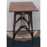 An Arts and Crafts oak occasional table, the square moulded top, above twelve spindles,