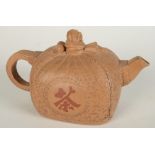 A Chinese Ixing stoneware teapot modelled as a seal wrapped in a cloth and tied in a bow to form