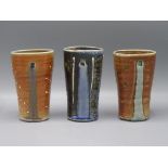 Three Ruthanne Tudball glazed stoneware beakers, height of tallest 14.4cm.