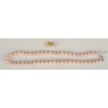 A cultured pink pearl necklace with white gold diamond set 14ct clasp,