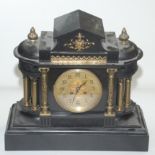 A Victorian black slate mantel clock, surmounted by a pair of acanthus leaf decorated finials,
