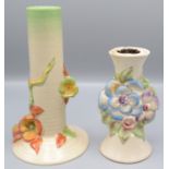 Two Clarice Cliff candlesticks, each floral decorated, numbers 927 and 724, heights 18.5 and 13.5cm.