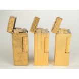 Three gold plated Dunhill gas made in Switzerland Rollagas lighters patent 24163.