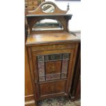 An Edwardian inlaid rosewood cabinet, with numerous mirrored plates and a single door,