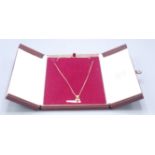 A 9ct gold necklace with a petal drop set with a heart shaped garnet and two diamonds, 5.3g.