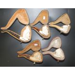 Five meerschaum pipes, some with attached sticker inscribed 'Admiral Meerschaum and Calabash',