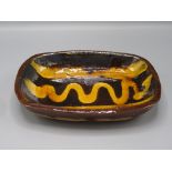 A Clive Bowen Studio Pottery slipware dish, 17.5 x 14cm.