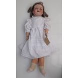 A porcelain head doll, the head with sleep eyes,