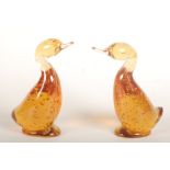 A pair of Whitefriars amber glass ducks, height 14.5cm.