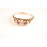 An 18ct gold Edwardian ring set three diamonds and two rubies.