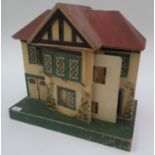 A small Tri-ang wood and tin dolls house with typical tin windows and doors, width 19",