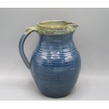 A Ray Finch Winchcombe Pottery jug, with a blue mottled ground, height 20cm.