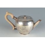 A Britannia standard silver bullet form bachelors teapot by Crighton, London 1918, engraved crest.