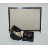 A patent EPNS photograph frame and a silver napkin ring, cased.