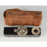 A black metal rangefinder, in original leather case, height 7.5cm.