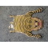 A Tibetan rug, in the form of a tiger, 180 x 98cm. Condition report: No label.