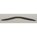 An Australian Aborigine boomerang of plain curved form, width 62cm.