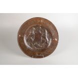 A circular copper armorial plaque, early 20th century,