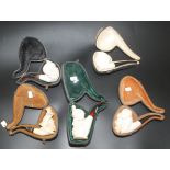 Five meerschaum pipes, one with an attached sticker inscribed ' Meerschaum Koncak Eskisehir Turkey'.