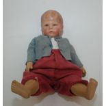 A Kathe Kruse boy doll, the head moulded and lacquered fabric,