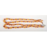A double strand amber bead necklace with graduated oval butterscotch beads, the largest 14.