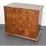 A walnut chest of drawers, early 18th century, with two short and three long graduated drawers,