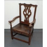 A George III carved oak armchair, with a pierced splat, solid arms and seat , height 102cm.