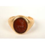 An 18ct gold signet ring the carnelian carved with a stag.