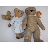 Two kapok filled love worn teddy bears, the larger 28", together with two other soft toys.