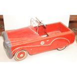 A 1950s tin plate pedal car, some restoration, full length 36".