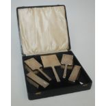 An engine turned six piece silver mounted brush set, Birmingham 1938.