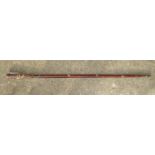 An eastern lacquered sword stick with button release, full length 91cm, blade length 42.5cm.
