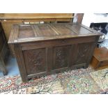 A 17th century oak joined chest the quadruple panelled top above a triple carved panelled front