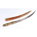 A Jambiya short sword, with a brass inlaid horn handle and leather sheath, inscription to the blade,