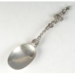 A silver apostle spoon with ornate stem.