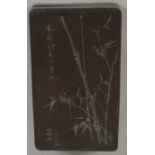 A Chinese stone ink box depicting birds perched on bamboo with calligraphy, 13.3 x 7.7cm, height 2.