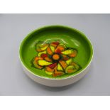 A Poole Pottery footed bowl, the green ground with a central abstract design,