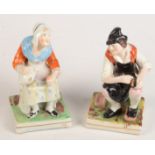 A pair of Staffordshire figures of a cobbler and his wife, 19th century, height 16cm.