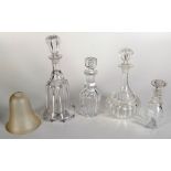 Four various glass decanters, largest height 33cm and a frosted glass shade, height 13.5cm.