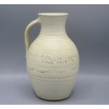 A Ray Finch Winchcombe Pottery jug, with a cream ground and abstract designs, height 24cm.