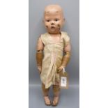 A carved wood "baby face" toddler doll by Schoenhut,