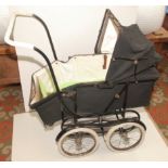 A 1950s or 1960s metamorphic pram, the feet end drops to make a pushchair, repainted,