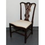 A George III mahogany dining chair, the shaped leaf carved top rail above a pierced splat,