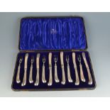 A set of six dessert knives and forks with silver plated blades and filled silver pistol grip