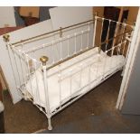 A late Victorian or Edwardian brass and iron cot with iron strap base and later wood and metal