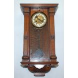 A walnut wall clock, 19th century, height 65cm and a Bakelite mantel clock, height 14cm, width 19.