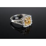A very fine fancy vivid yellow diamond and platinum ring with Coloured Diamond Report dated 2013